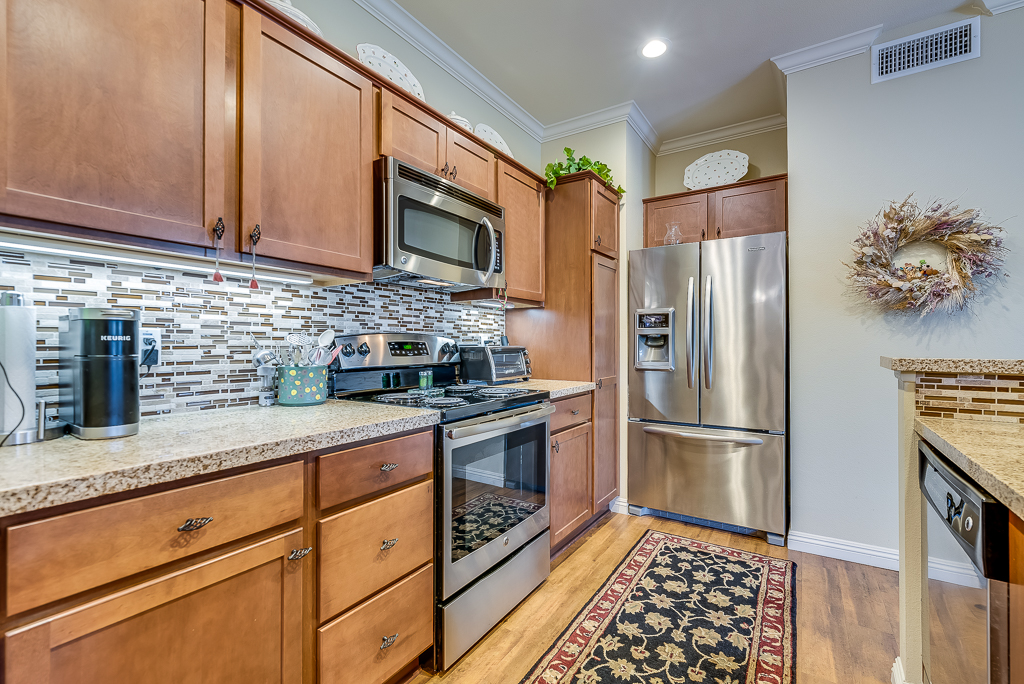 Kitchen full kitchen with brown cabinetry and stainless steel appliances